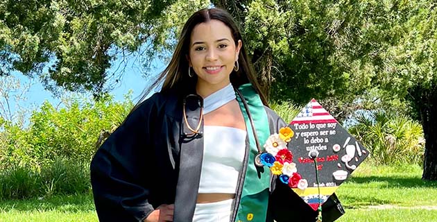 Graduate holding decorated cap