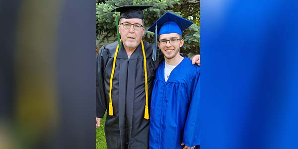 Two male graduates smiling