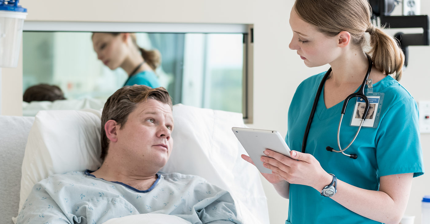 female nurse talking to male patient