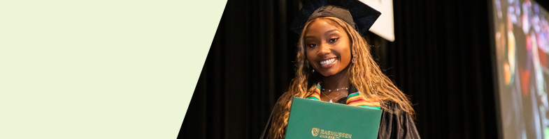 Rasmussen graduate holding a diploma smiling