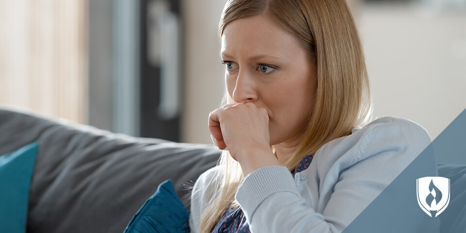 female watching TV on her couch