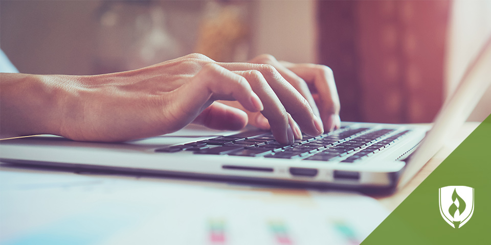 hands typing on a laptop