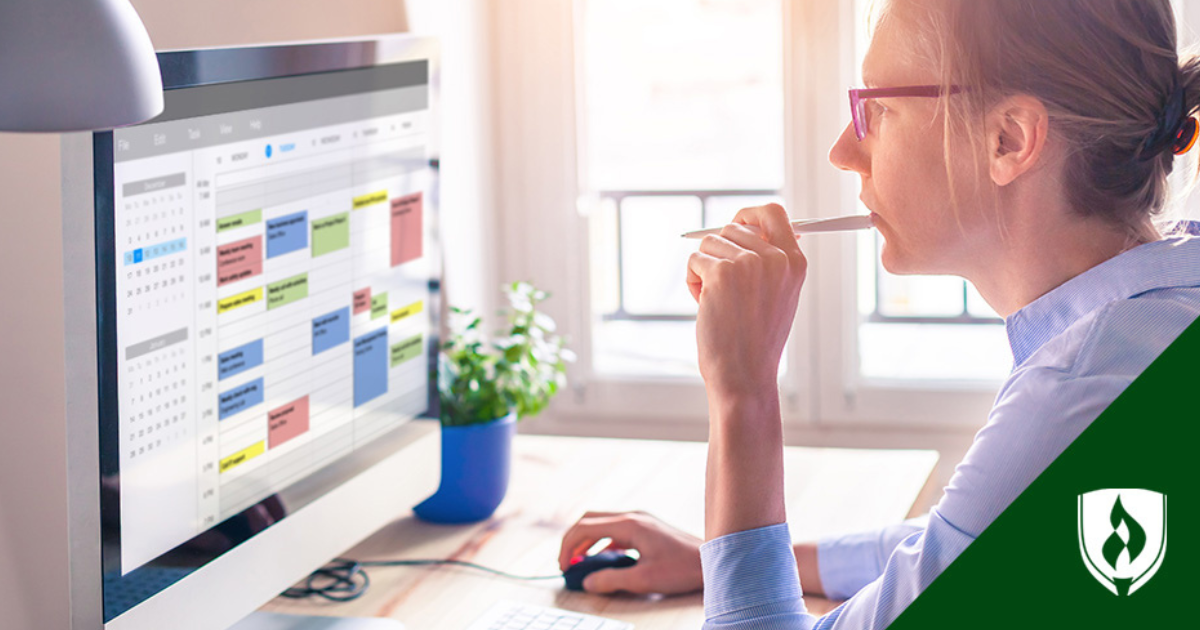 A student in pink glasses stares at a calendar on her computer