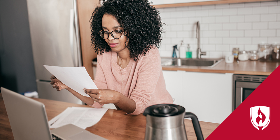 woman reading papers at a desk