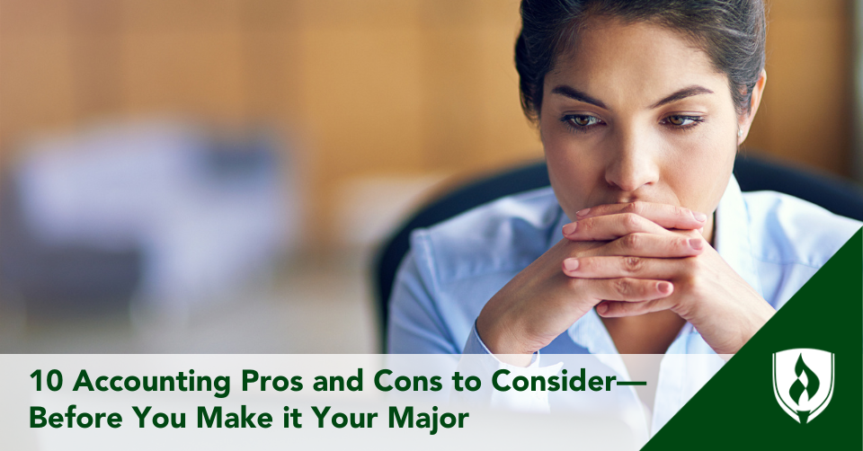 An accountant stares pensively at her desk, deep in thought