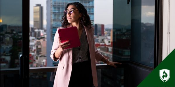 A business administration professional looks out over a city skyline