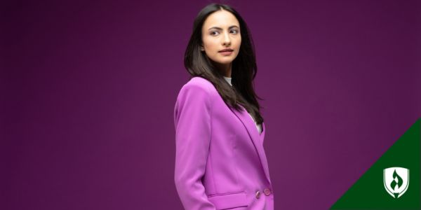 A Business Leader looks over her shoulder in a purple blazer