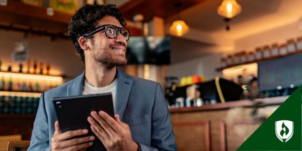 A business professional holds a tablet