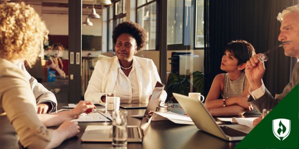 A corporate lawyer and business lawyer meet with executives