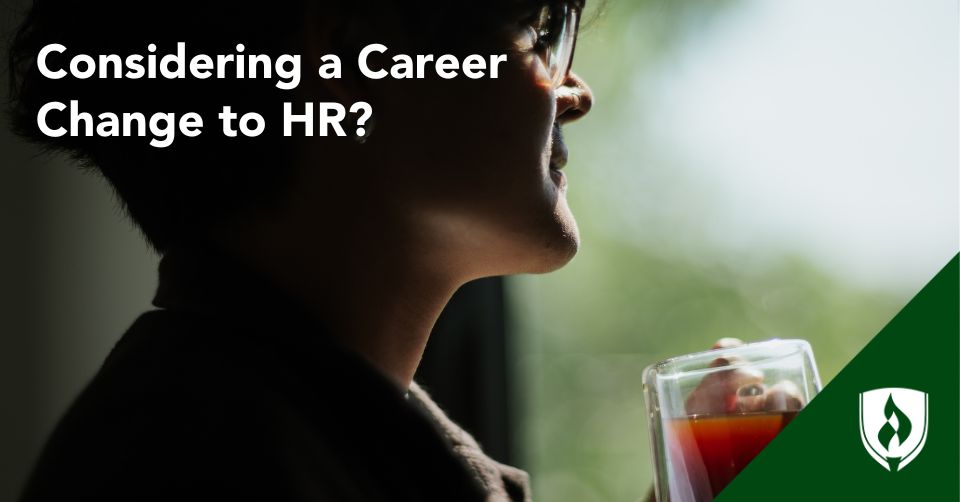 career change to HR header Someone stands at a window, silhouetted in shadow, drinking a cup of tea