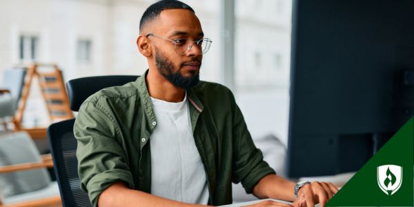 A person types on a computer looking into retail management