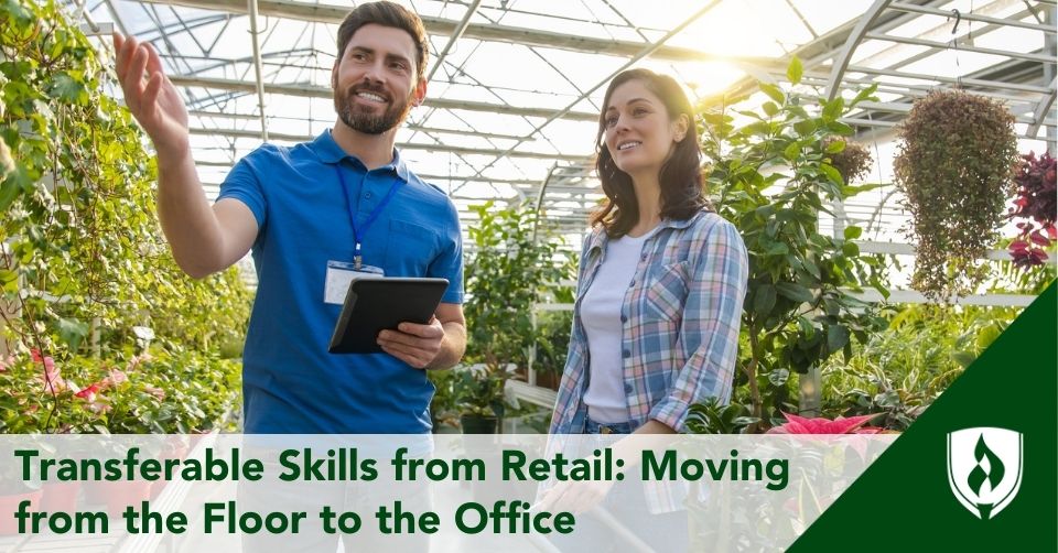 A retail worker helps a customer in a greenhouse
