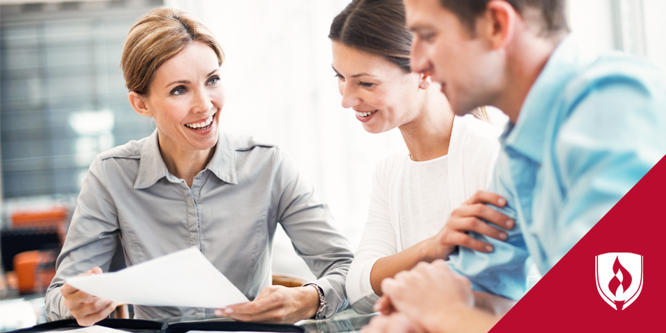 business woman sitting at table with clients