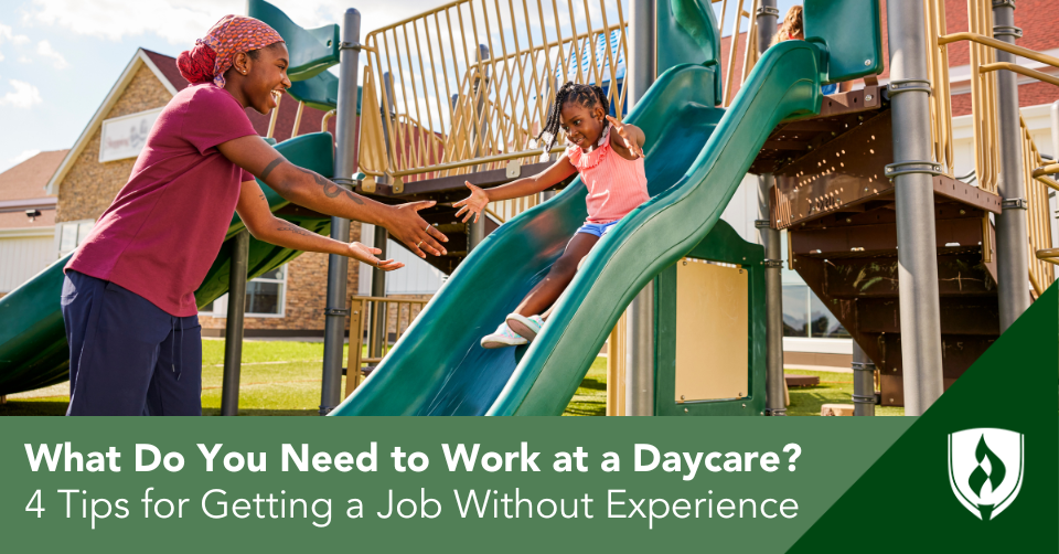 A daycare teacher holds out her arms to catch a little girl going down the slide