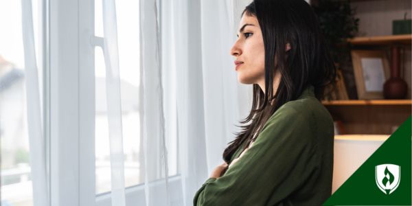 An ECE teacher looks out her window with a tired expression