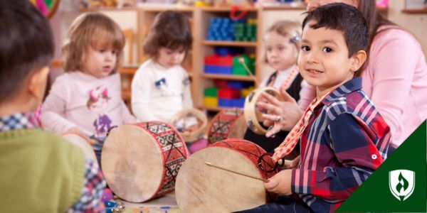Preschoolers and toddlers play with drums