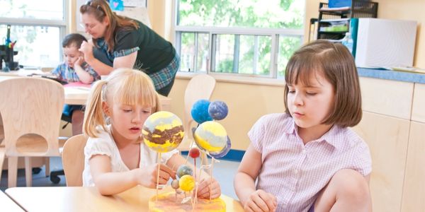 young children with a teacher in a classroom
