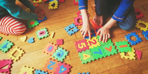 children assembling a puzzle