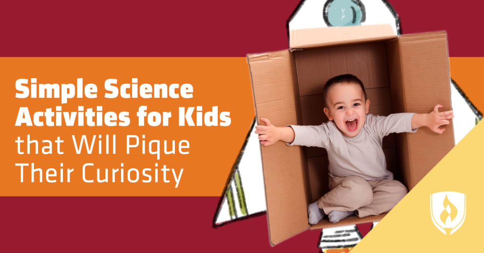 Young boy playing in a cardboard box made to look like a spaceship