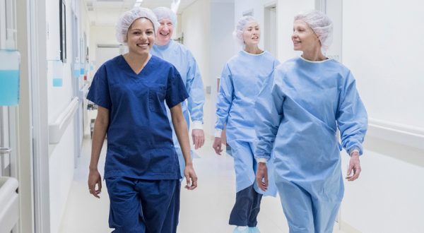 Surgical techs walk down the hall of a hospital