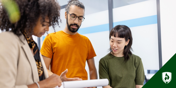 Three professionals discuss plans at a non-profit organization