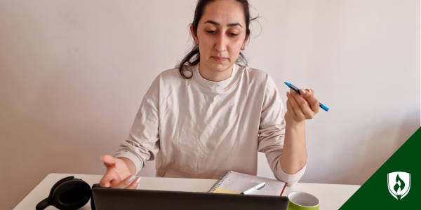 A prospective nursing student sits over a notebook looking baffled