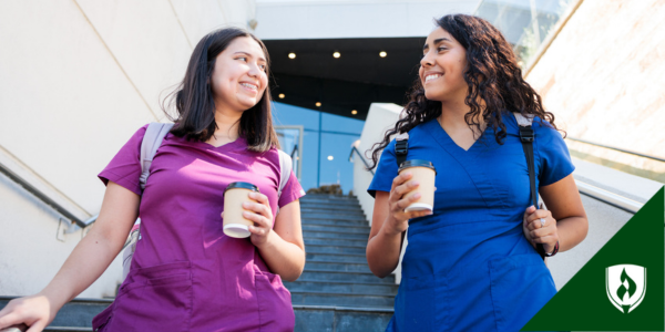 Two Associate degree nurses chat while walking out of their healthcare facility