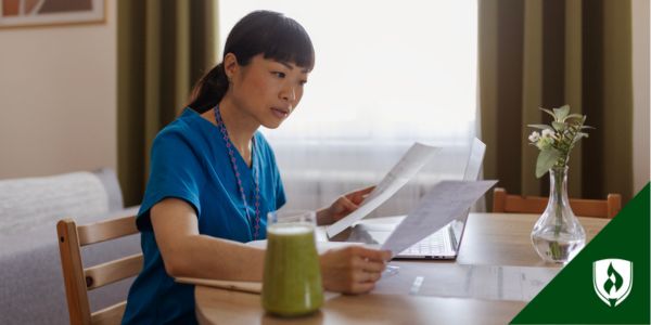 A nurse sits at her computer at home comparing RN to BSN programs