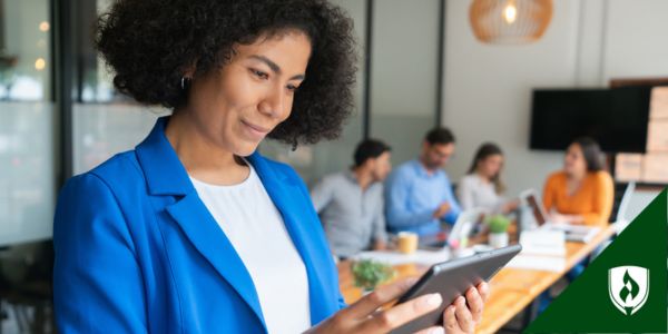 A nurse in a blue blazer goes into a meeting