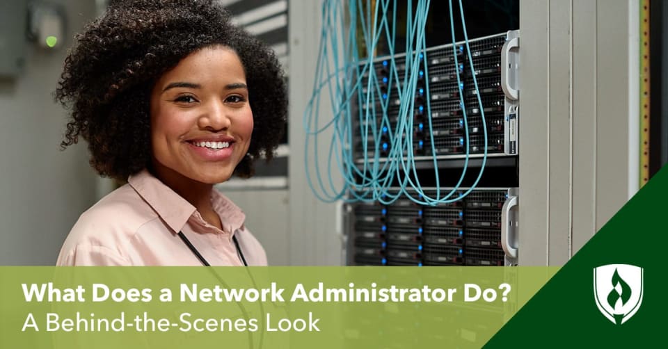 A female network administrator standing in front of a server cluster