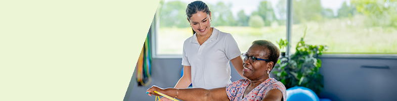 Physical therapist assistant helping a patient with exercises