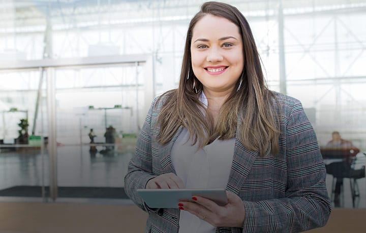 Smiling business woman with tablet mobile